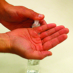 Photo of person applying hand sanitizer to hands