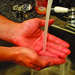 Photo of person wetting hands