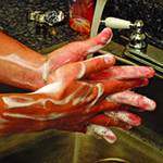 Photo of person lathering soap on their hands