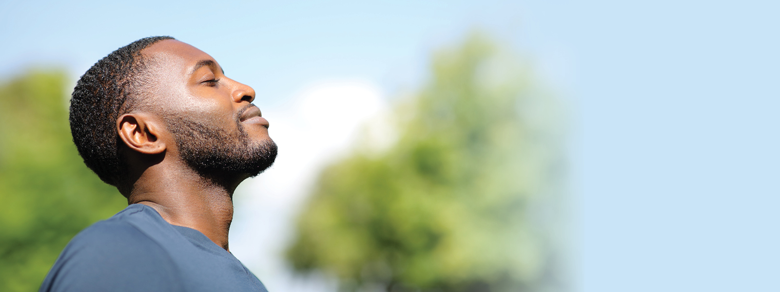 Photo of man breathing in fresh air outdoors