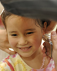 Girl getting ears pierced