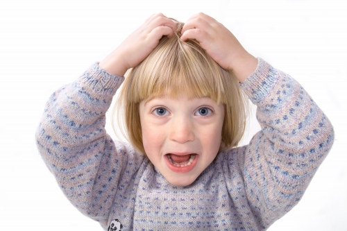 A girl scratching her head.