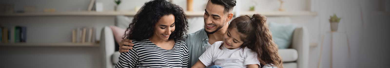 Photo of pregnant woman with husband and daughter