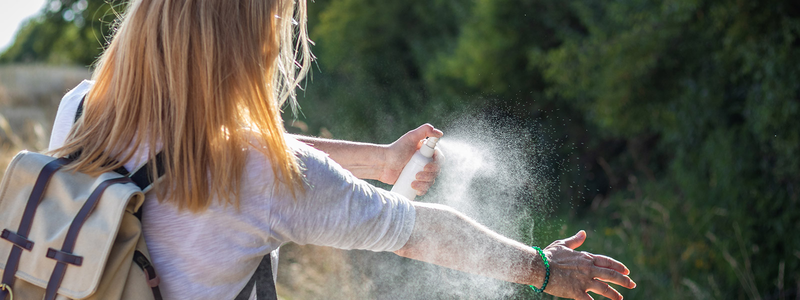 Woman spraying bug spray