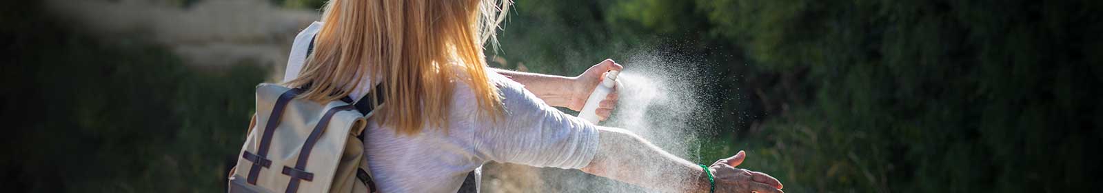 Woman spraying bug spray
