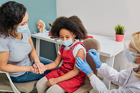 Photo of a young girl receiving a vaccination