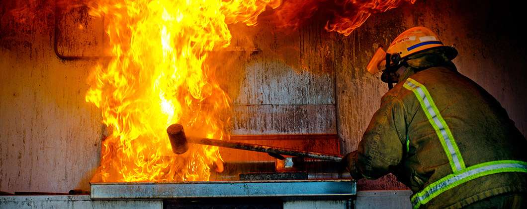 Photo of firefighter putting out fire in restaurant kitchen