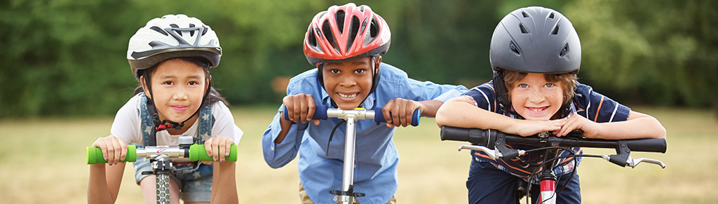 Photo of children on bikes and scooters