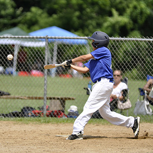 Boy hitting a baseball with a bat