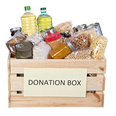 Photo of various food items in a donation box