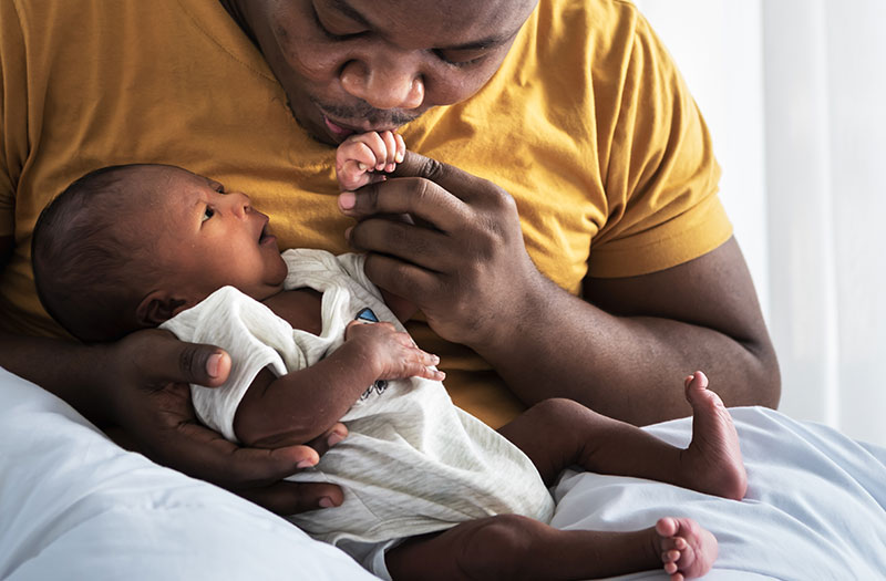 father holding a new born baby