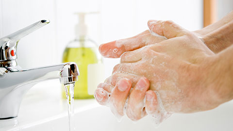 Photo of person washing their hands with soap