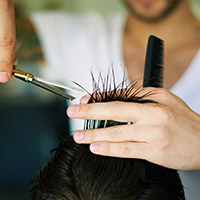 Photo of man getting haircut