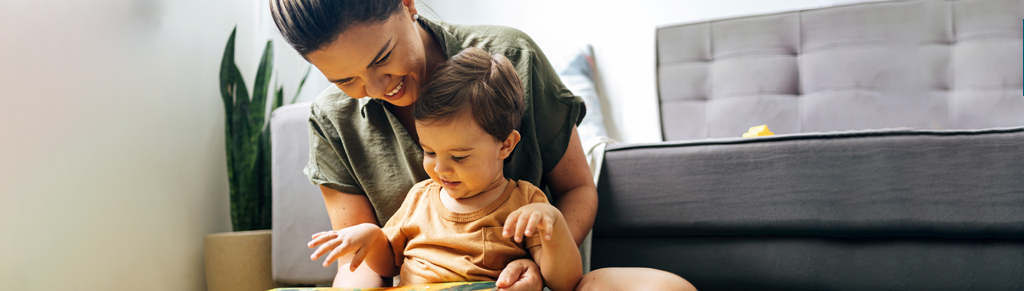 Picture of a mother reading a book with her child