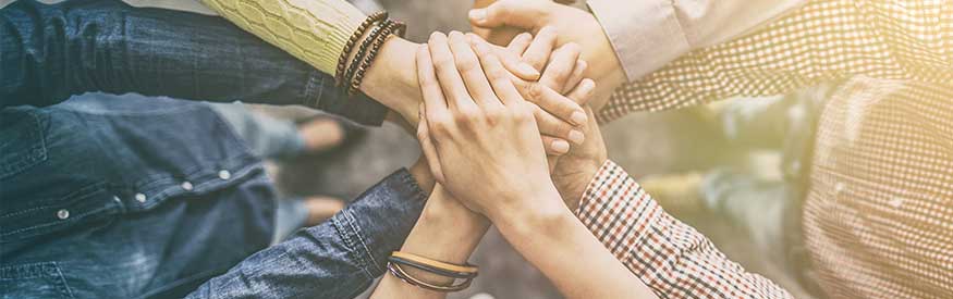 photo of peoples hands on top of each other